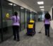 Office cleaning team cleaning glass walls and floors in a Toronto office corridor