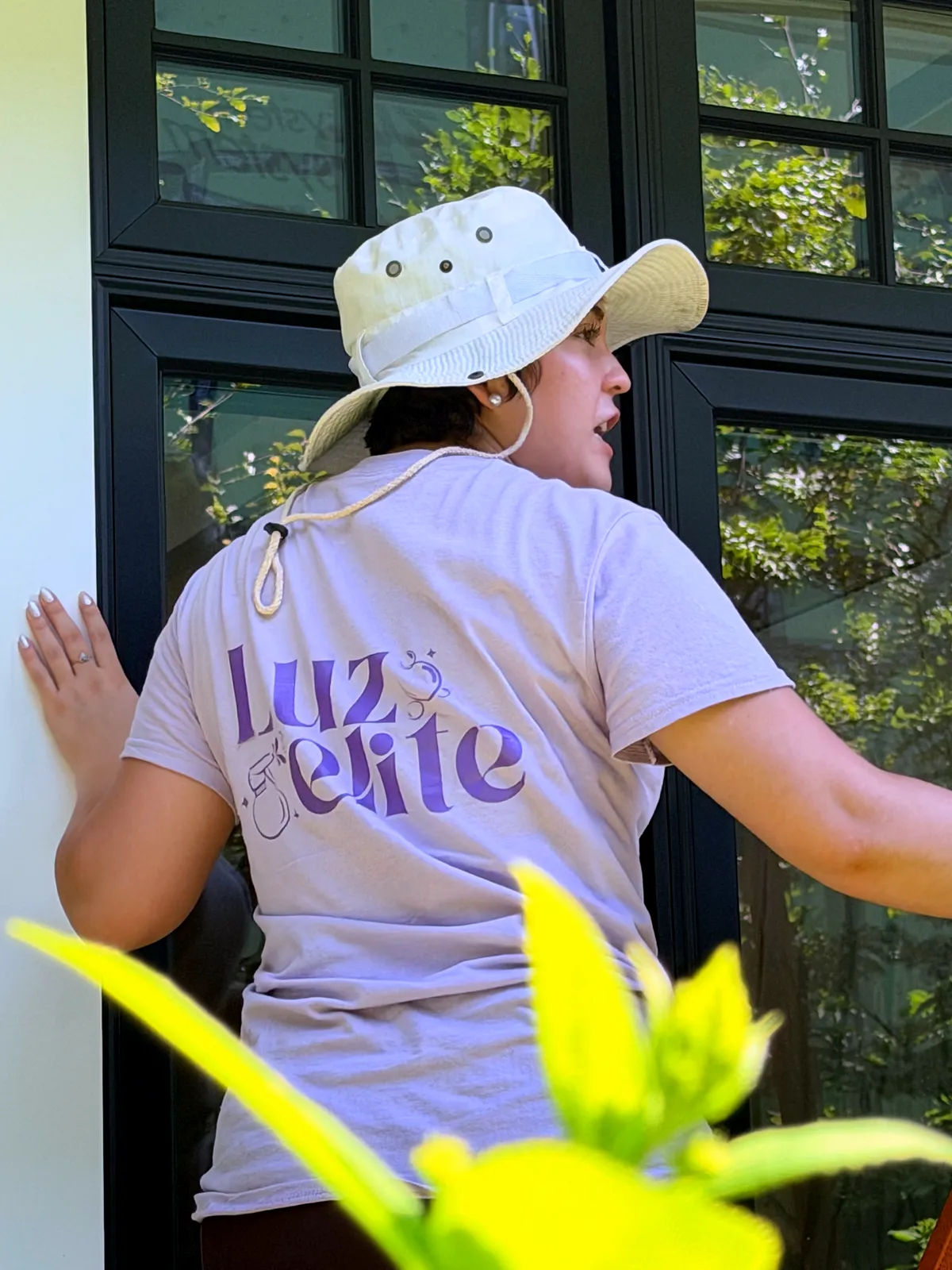 Luzelite team member cleaning windows